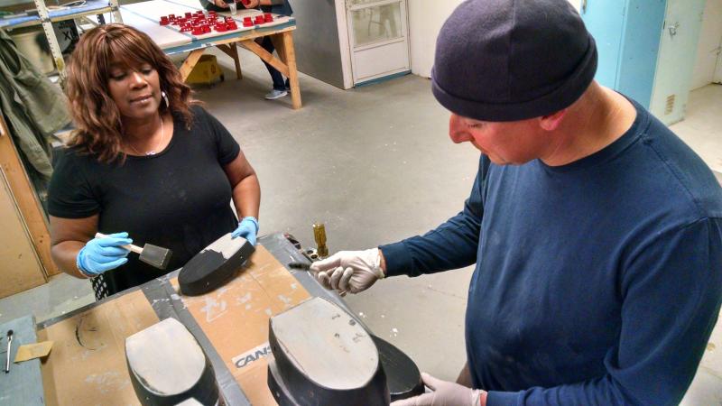 Hodgdon Yacht Services employees Christy Joiner, left, and Charles Lopez work on handmade Christmas presents for Lincoln County families in need this holiday season through a partnership with Toys for Tots. MARGARET HOFFMAN/Boothbay Register