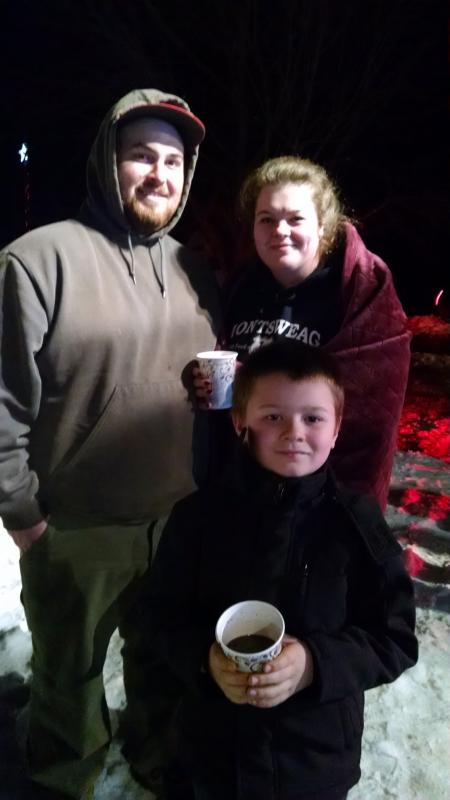 Joseph Hersom, left, Melissa Mackusick, right, and Carson Cook, front center, arrive early and enjoy hot chocolate while waiting to meet Santa. MARGARET HOFFMAN/Boothbay Register