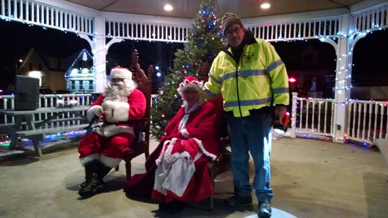 Fire Chief Dick Spofford helps Santa and Mrs. Claus to their seats. MARGARET HOFFMAN/Boothbay Register