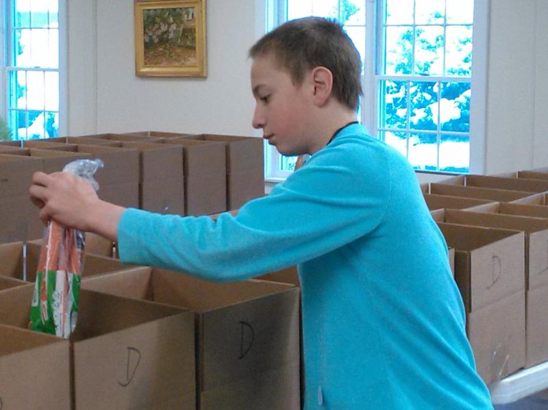 Carrots are added to a Thanksgiving dinner box. JANE CARPENTER/Boothbay Register