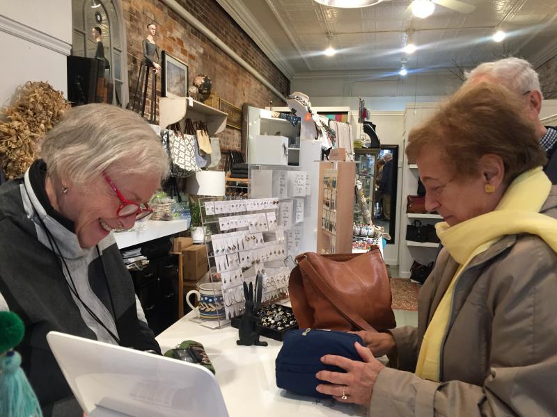 DebraElizabeth's owner Deb Schaffer, left, and Early Bird shopper and new Edgecomb resident Pat Stauble, owner of Patricia Stauble Antiques in Wiscasset, complete a transaction. SUSAN JOHNS/Wiscasset Newspaper