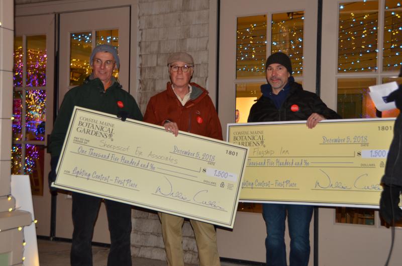 Tying for first place in the business category were Sheepscot Eye Associates – represented by Greg Barter, left, and Tom Nadeau, center – and Flagship Inn, represented by Aaron Blake. On behalf of Boothbay Region Food Pantry, Barter accepts SEA’s winnings from Nadeau. Courtesy photo