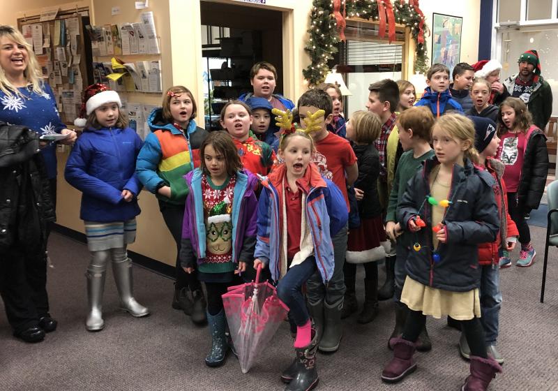 A traveling chorus from Southport Central School sang for the Community Center Dec. 21. Meredith Fowlie, guidance and cultural studies teacher, is at the left. Courtesy of Jen Field