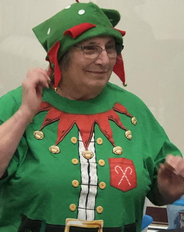 Community Center volunteer Connie Heroy donned her best elf apparel to welcome pre-school singers from Lighthouse Learning Center at the Community Center on Dec. 13. Courtesy of Jen Field