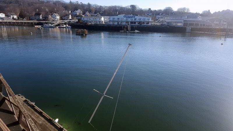 The mast is the only thing seen of this sailboat, pinned underneath the dock against pilings at Mystic Mermaid. STEVE EDWARDS/Boothbay Register