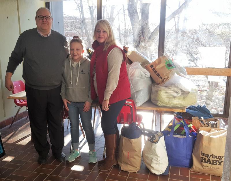 Suzie delivering clothes for kids from The Clothing Closet collection on Jan. 2 to Boothbay Region Elementary School. Accepting the donations are BRES Principal Mark Tess and Assistant Principal Trish Campbell. STEVE EDWARDS/Boothbay Register