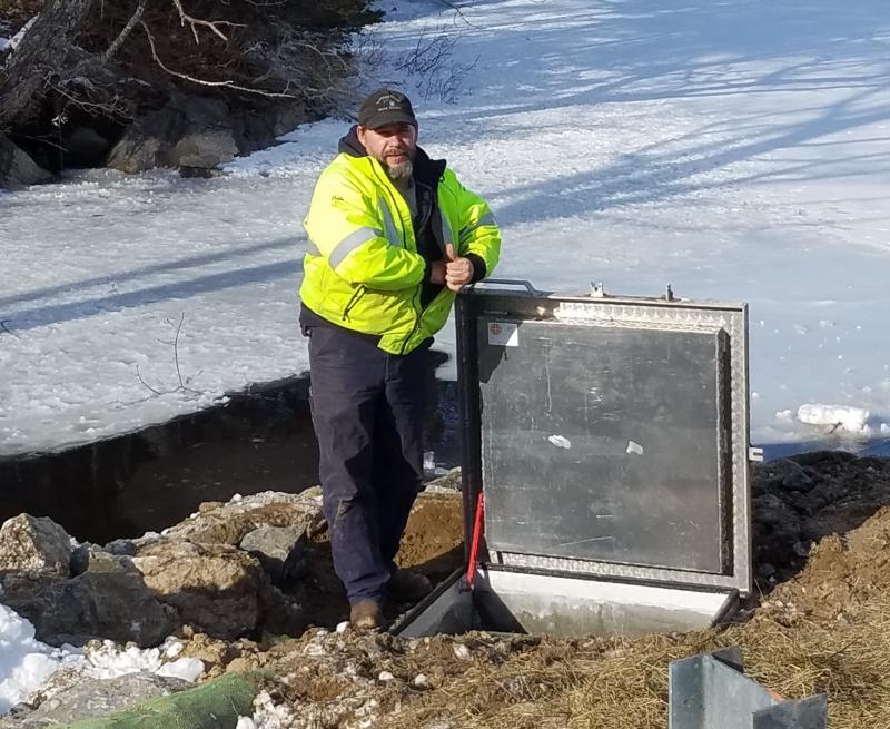 Dale Harmon, operations manager of Boothbay Region Water District, beside the manhole cylinder he and his crew assembled, after installation. Merritt Blakeslee photo