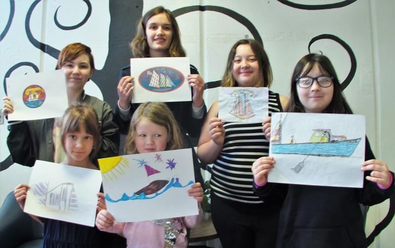 Six of the eight students who submitted designs for the first WJD T-shirt design contest and their entries: front, from left: Megan Higgins, Pauline Nadeau-MIller; back, left: Amber Johansen, Grace Campbell (with the chosen design), Maya Pangburn and California Brown. Missing from photo: Keana Pitcher and Bobby Clarkson. LISA KRISTOFF/Boothbay Registser