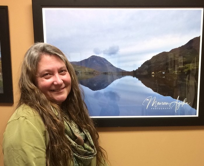 Maureen Dittmer pauses for a Kodak moment after hanging her show at Atlantic Motorcar. Courtesy of Alicia Howes Maureen Dittmer