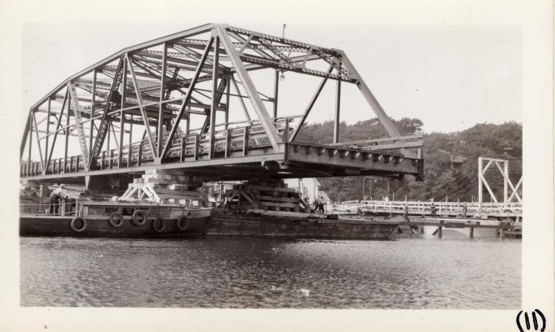 A barge brings in the bridge. Courtesy of MDOT historic bridge archives