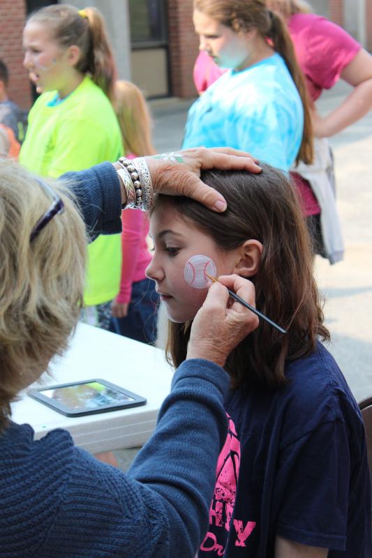 Natalie Flagg sits still as a baseball is drawn on her face. The face painting station was the most popular station during the festivities. PAGE BROWN/Boothbay Register