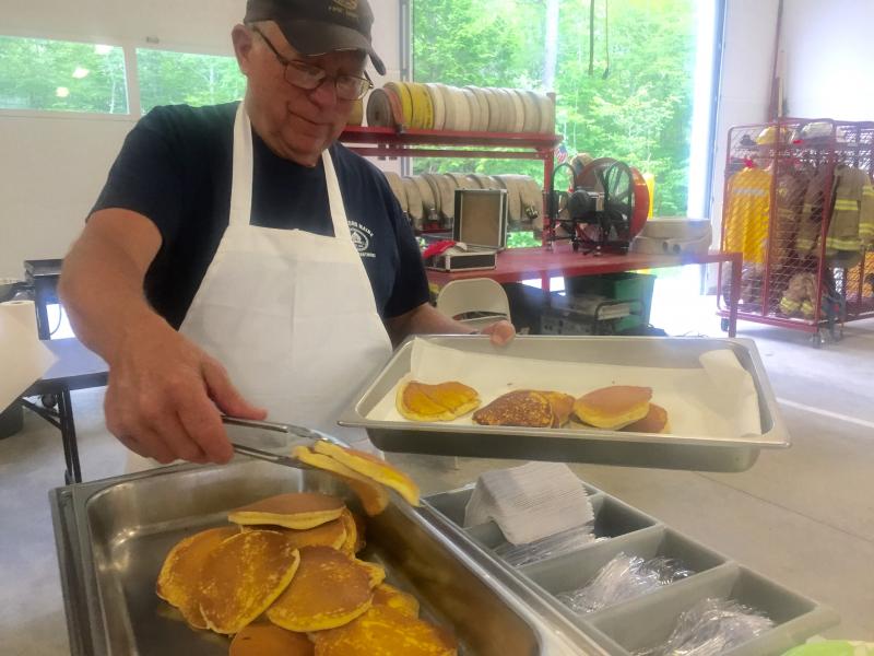 Edgecomb Fire Department member Bill Witzell updates the pancake tray at the auxiliary’s June 29 breakfast at the station. SUSAN JOHNS/Wiscasset Newspaper