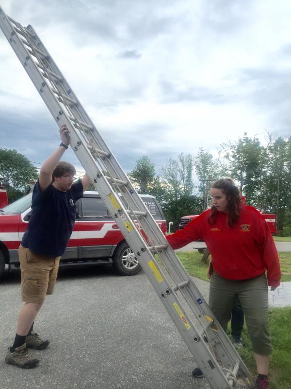 Edgecomb junior firefighter Aidan Tracy gets some ladder training with department member Leah Potter. SUSAN JOHNS/Wiscasset Newspaper