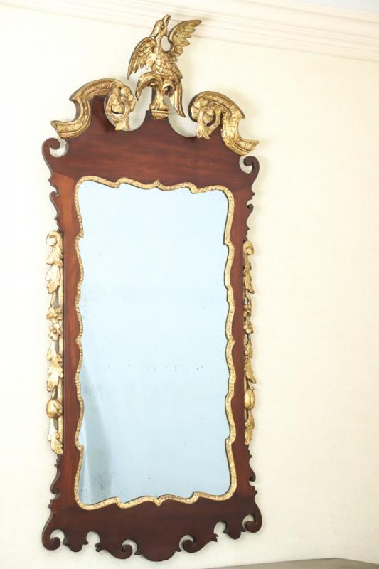 18th century Chippendale looking glass mirror by John Eliot (Philadelphia), with a carved and gilt Chinese-inspired eagle, made from mahogany veneer and gilded wood, 49 ½” X 23 ½.”