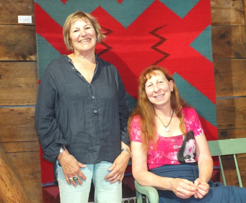 Priscilla May Alden, left, and Barbara Burns pose in front of Alden’s piece, “Rio Grande Flow.” LISA KRISTOFF/Boothbay Register