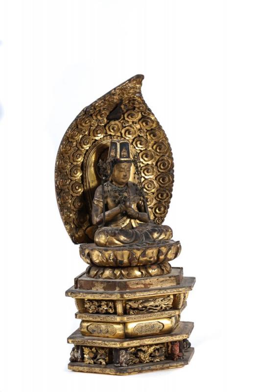 18th century carved Chinese and gilt seated Buddha, 25” tall, with the Buddha depicted seated on a lotus, wearing jewelry and a headdress.