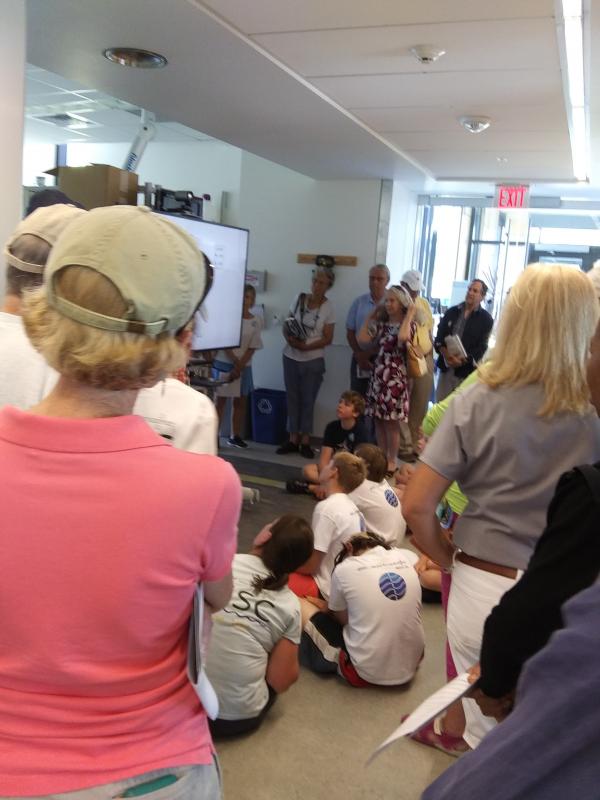 Guests at Bigelow Laboratory’s open house July 19 found any space available as they heard from scientists. JANE CARPENTER/Boothbay Register
