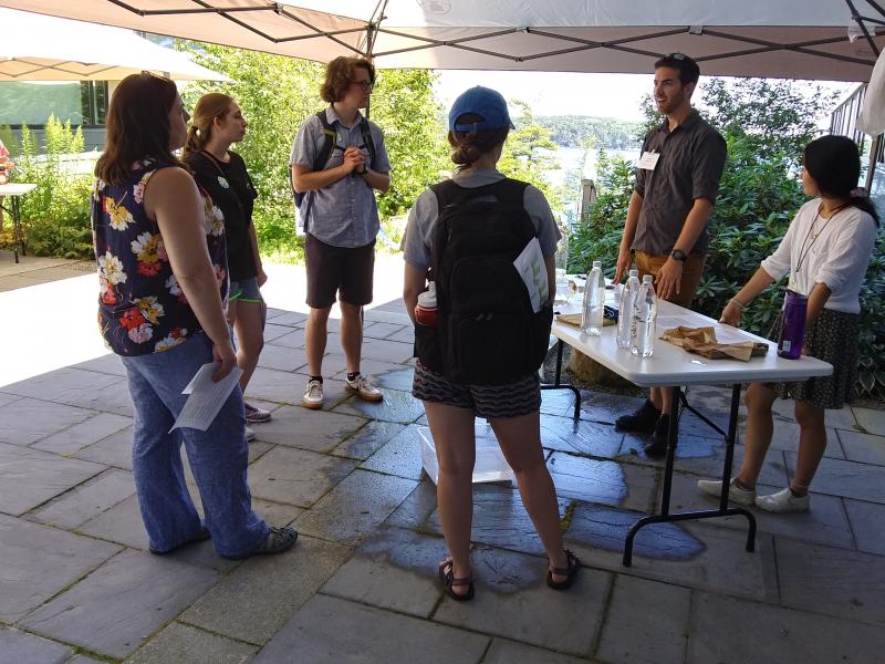 Members of Brunswick’s Outward Bound group hosted by Bowdoin College learn what happens at the open house’s “under pressure” exhibit. JANE CARPENTER/Boothbay Register