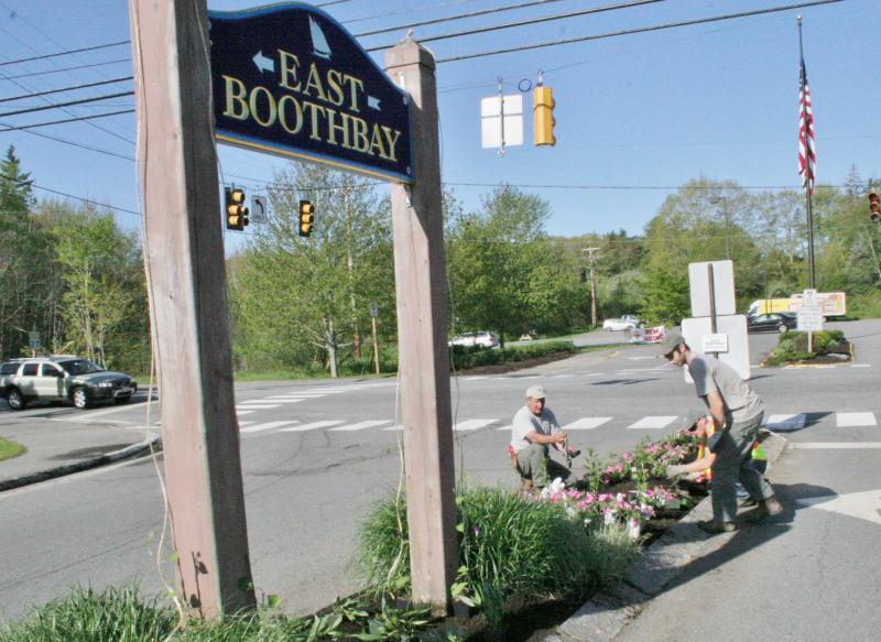 A scene from a 2014 story on the traffic island beautification. The posts and sign are the ones destroyed this past February. File photo