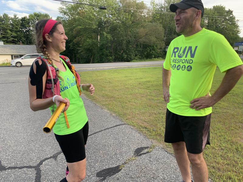 Run 2 Respond runner Tanya Holbrook and Firefighter Five Foundation founder Steve Bender await Woolwich Fire Department’s arrival in Wiscasset for the relay. SUSAN JOHNS/Wiscasset Newspaper