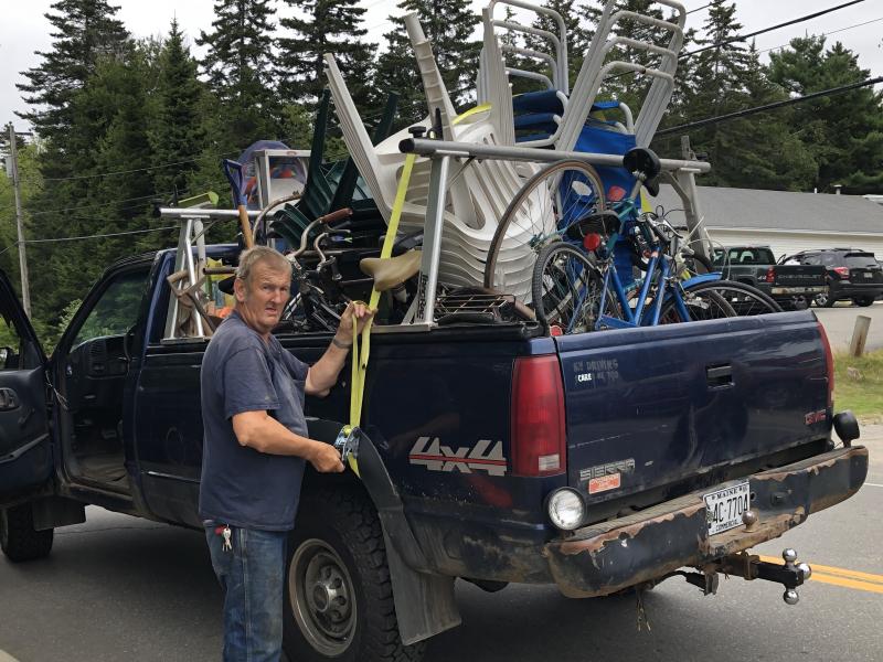 Ted Rideout of Whitefield with the pickup he arrived in that became loaded with buys. He also bought a Ford pickup at the auction, which he also loaded with bargains. JENNY BENNETT/Boothbay Register