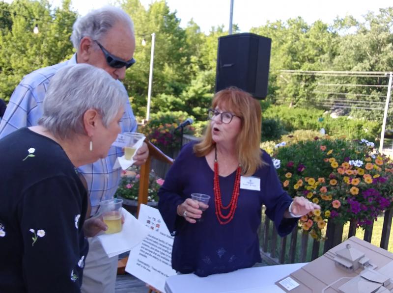 Susan Wilson, right, Kenniston House Project chair, discusses the model campus with Don and Chris Kenniston. Don Kenniston is descended from William Kenniston. JANE CARPENTER/Boothbay Register