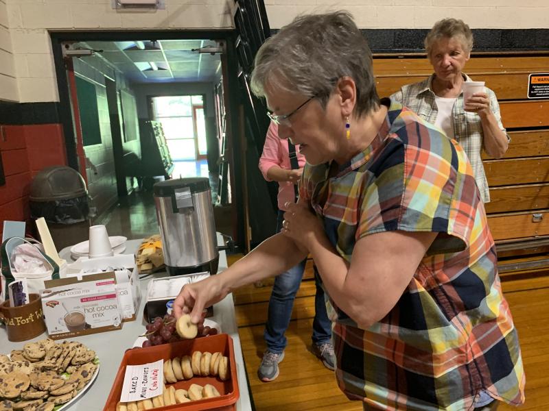 Judy Flanagan of Wiscasset chooses a snack at the bicentennial lecture. SUSAN JOHNS/Wiscasset Newspaper