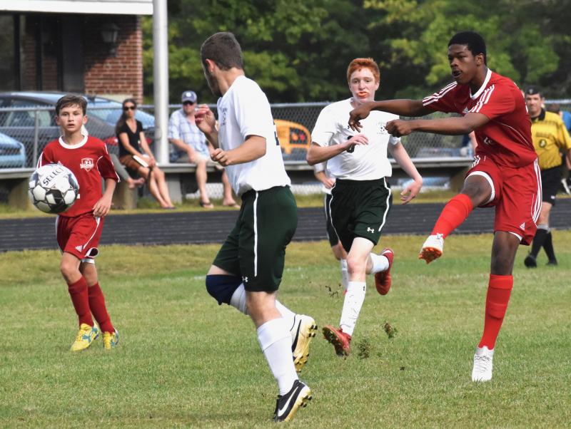 Jordan Espeut, right, fires a shot in the first half. Also shown is Payton Blagdon. PHIL DI VECE/Wiscasset Newspaper