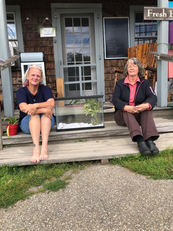 Sue Aubuchon and Lorrie Davis with one of the monarch tanks at Morris Farm. JENNY BENNETT/Boothbay Register