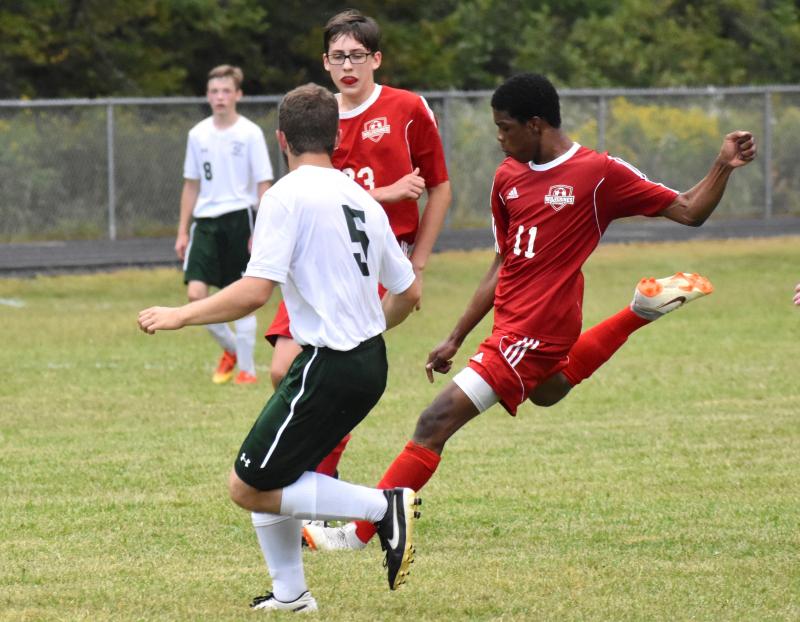Jordan Espeut on the right scored two goals for Wiscasset/Boothbay vs Carrabec. Also shown is Wolverine Garrett Cossette. PHIL DI VECE/Wiscasset Newspaper