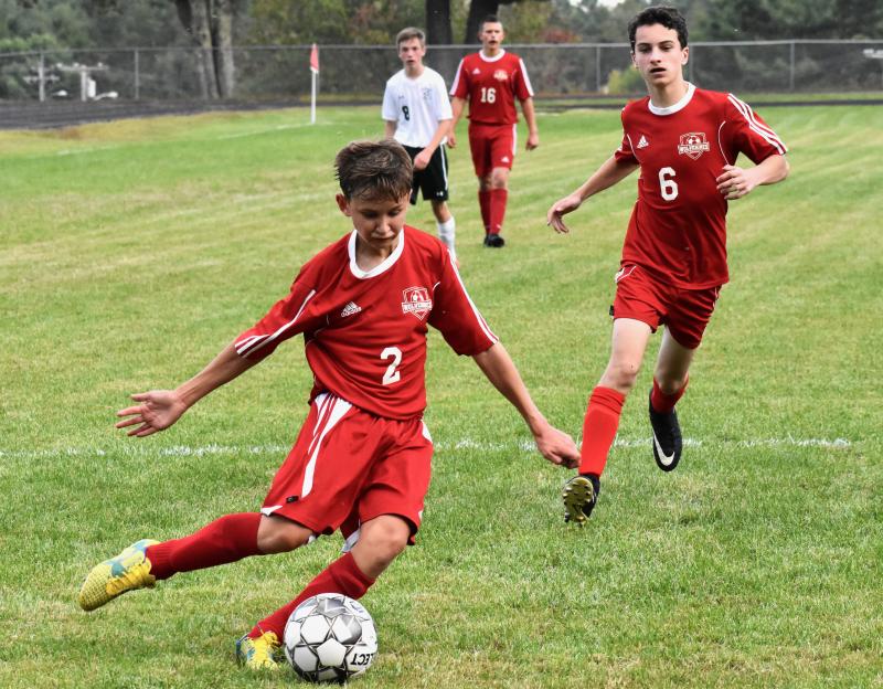 Freshman Payton Blagdon with the ball got the goal that sent the Sept. 11 game with Carrabec into overtime. Also shown is Payton’s older brother Chance Blagdon. PHIL DI VECE/Wiscasset Newspaper