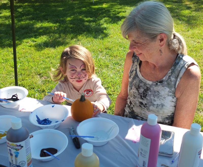 Arbor Lewis shows her grandmother Star Perkins her freshly painted face on Sept. 21 during Family Harvest Days. BILL PEARSON/Boothbay Register