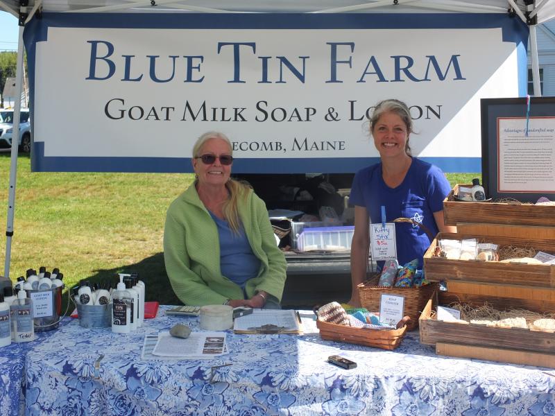 Penny Theall, left, and Crystal Lewis sell organic pork and goat’s milk soap and hand lotion Sept. 5 during the Boothbay Farmers’ Market. BILL PEARSON/Boothbay Register