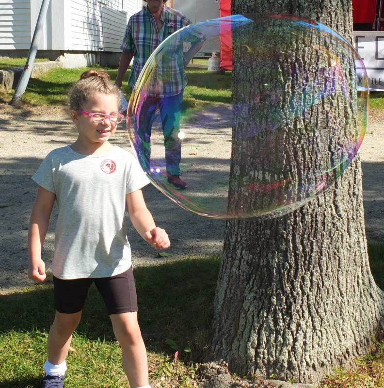 This Family Harvest Days guest checks out a huge bubble during the Sept. 21 and 22 event. BILL PEARSON/Boothbay Register