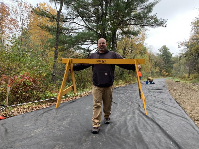 Brendan Barry of Merrimack, New Hampshire moves a sawhorse Oct. 12. SUSAN JOHNS/Wiscasset Newspaper