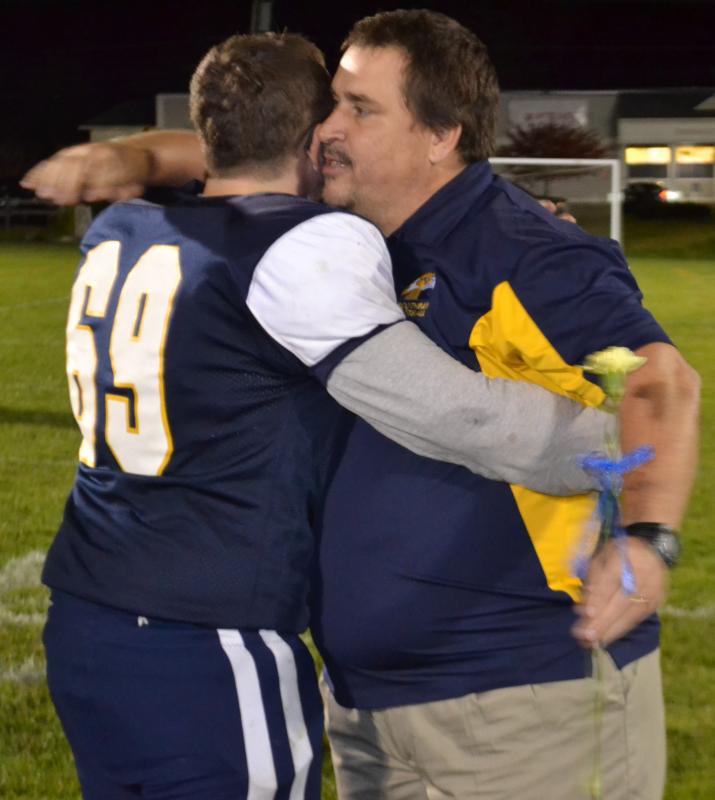 Boothbay center Dwight Lucas receives a hug from Coach Ed Crocker Oct. 11 during Seniors Night at Sherman Field. BILL PEARSON/Boothbay Register
