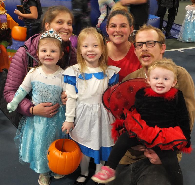 A princess met Alice in Wonderland during Trunk or Treat. Pictured, front row, from left, Kaliann Ellsworth, Lydia Ellsworth, and Justice Ellsworth held by John Ellsworth. Back row, from left, Brittani Kaiser and Shannon Ellsworth. BILL PEARSON/Boothbay Register