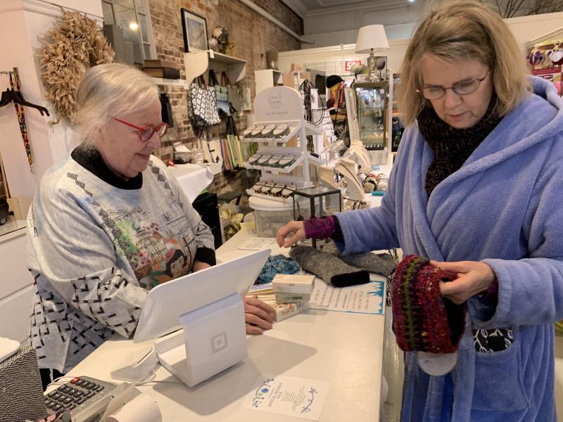 Margot Stiassni-Sieracki, right, checks out a headband at DebraElizabeths. At left, DebraElizabeths owner Deb Schaffer. SUSAN JOHNS/Wiscasset Newspaper