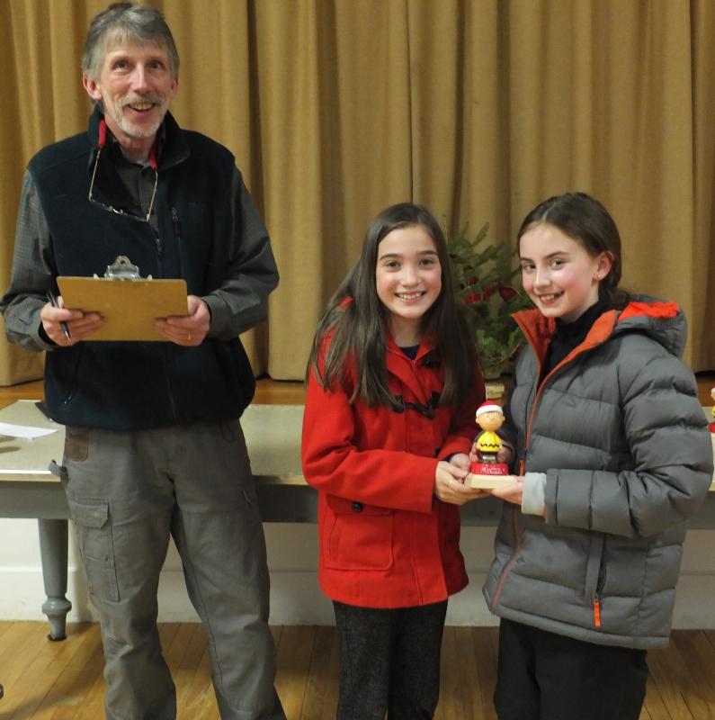 Selectman Mike Smith presents Edgecomb Eddy School students Hannah Abello and Eva Whitmore the Funniest Looking Tree Award for Julie Browne’s combined fifth and sixth grade class. BILL PEARSON/Boothbay Register