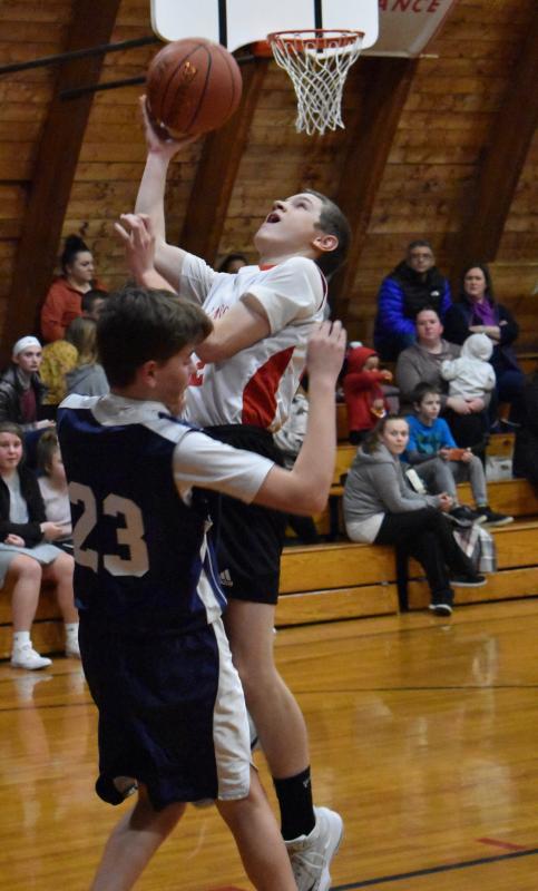Austin Trask attempts a layup over Boothbay’s Finn Harkins in the Busline League basketball game. PHIL DI VECE/Wiscasset Newspaper