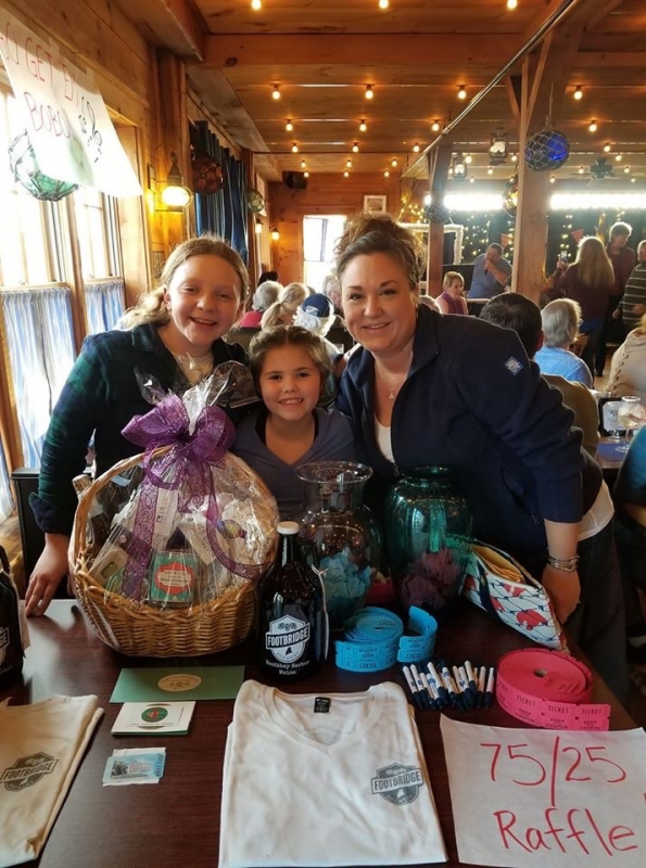 Suzie Edwards, Olivia Roberts and Kyndall Schmidt are all smiles at the raffle table. Courtesy of Jen Mitchell
