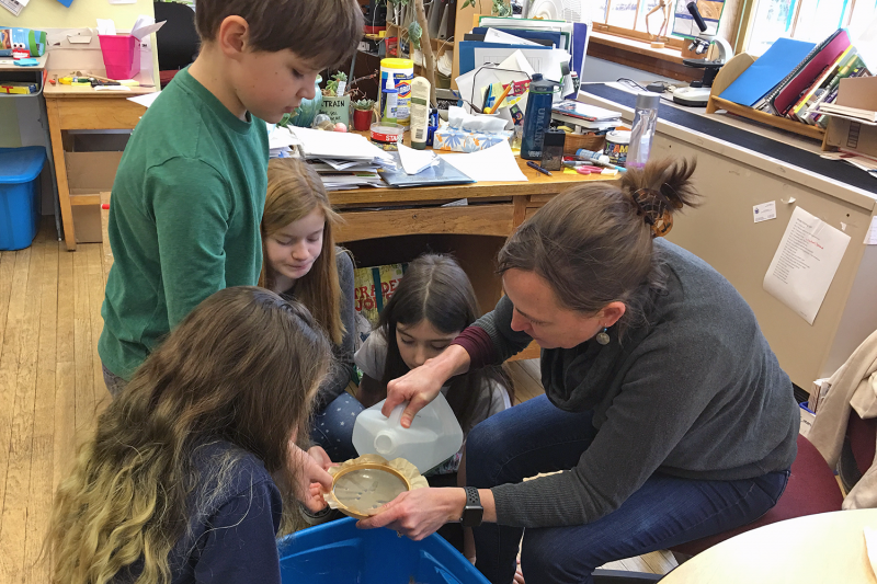 Marci Train, a teacher at Long Island School in Casco Bay, works with students Caroline Daughdrill, Silas Norton, Annabel Kimball, and Tilly Rich to sample local seawater for microplastics. Train will join a team from Bigelow Laboratory for Ocean Sciences to bring the experience of an upcoming ocean research cruise to students in Maine and beyond. Courtesy of Rebecca Clark Uchenna, Maine Mathematics and Science Alliance