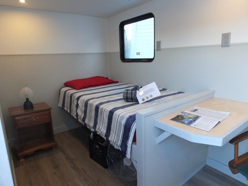 A new mobile shelter has a bed, chair, night stand, microwave oven, mini refrigerator and a heater. BILL PEARSON/Boothbay Register