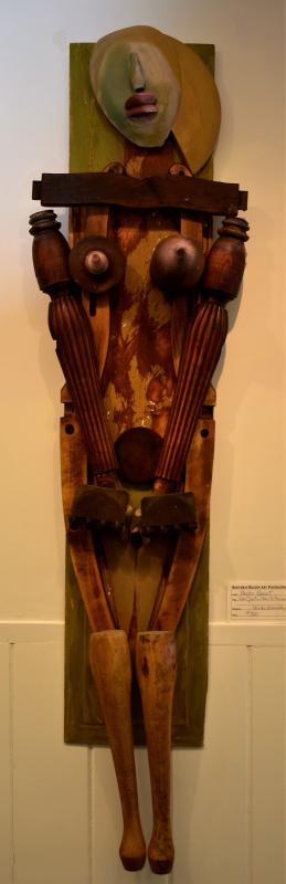 A wooden assemblage by Andre Benoit entitled, “Can’t Put A Face To the Name.” Andre Benoit, Maine