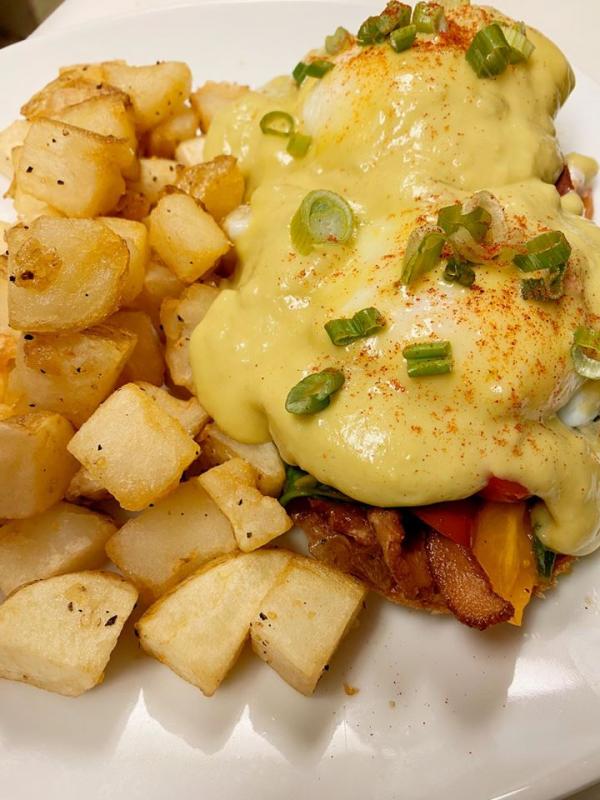 A Waves eggs “bennie” ... cherry tomato, apple wood smoked bacon, spinach, and an avocado hollandaise... Courtesy photo