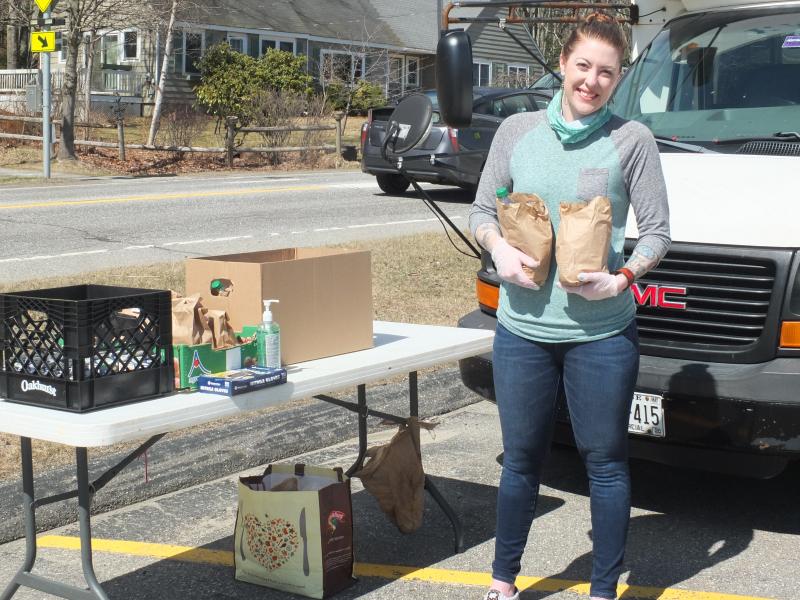 BRYMCA Development and Project Coordinator Stephanie Tucker, seen here without her usual mask, is responsible for distributing bag lunches each weekend as part of a community nutrition program. The coronavirus resulted in the Community School District and Y joining forces in providing weekend meals to local students. BILL PEARSON/Boothbay Register