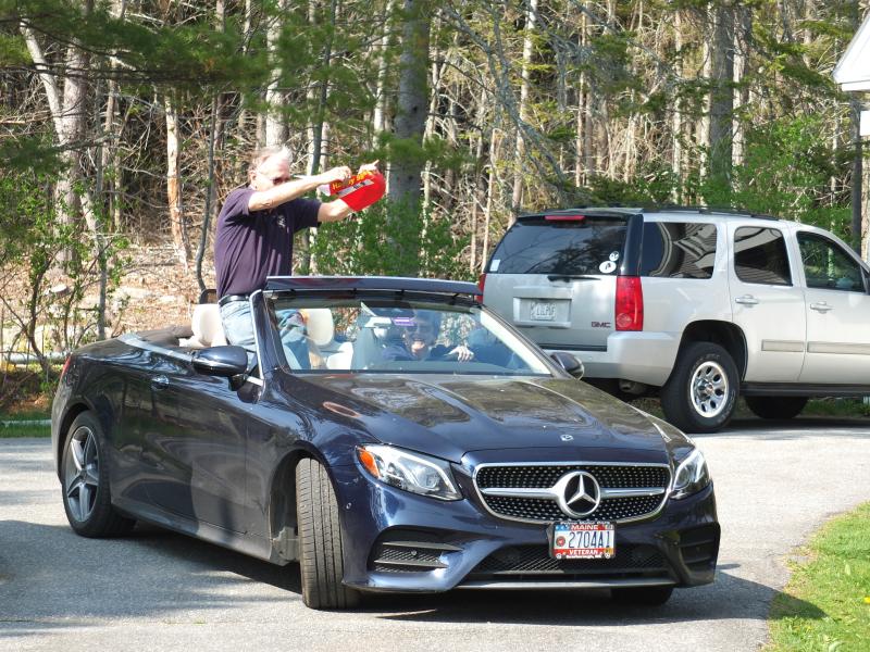 Jim Singer, with Becky Singer driving, celebrates John Druce’s birthday. BILL PEARSON/Boothbay Register