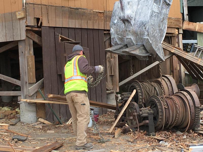 Workers find one of the giant winches that used to pull ships up onto shore. Courtesy of Bob McKay