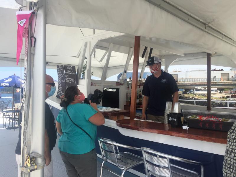 Bartender Killian Miller takes a drink order. LISA KRISTOFF/Boothbay Register