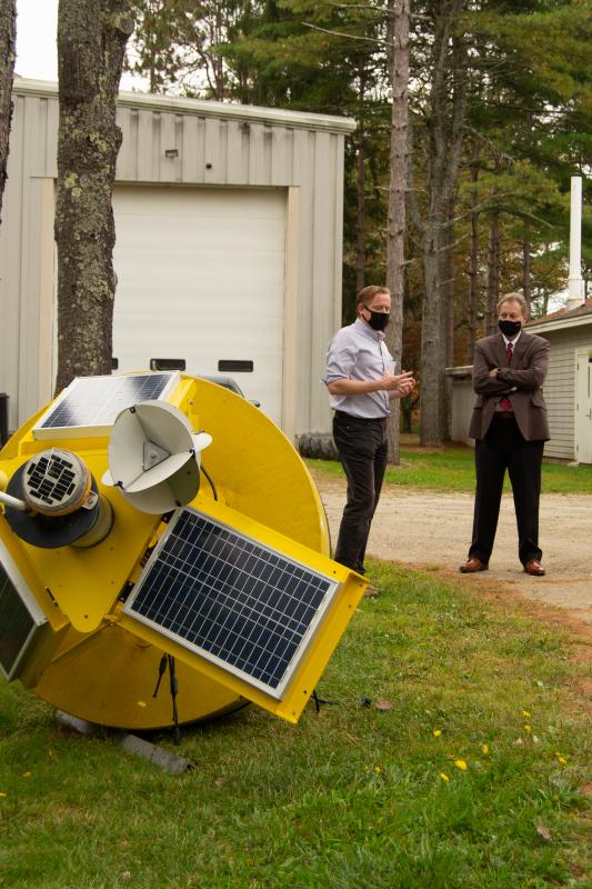 UMaine School of Marine Sciences faculty member Damian Brady and U.S. Assistant Secretary of Commerce Dana Gartzke discuss how coastal observing buoys deployed from the Darling Marine Center support marine research and environmental monitoring statewide. Courtesy of DMC